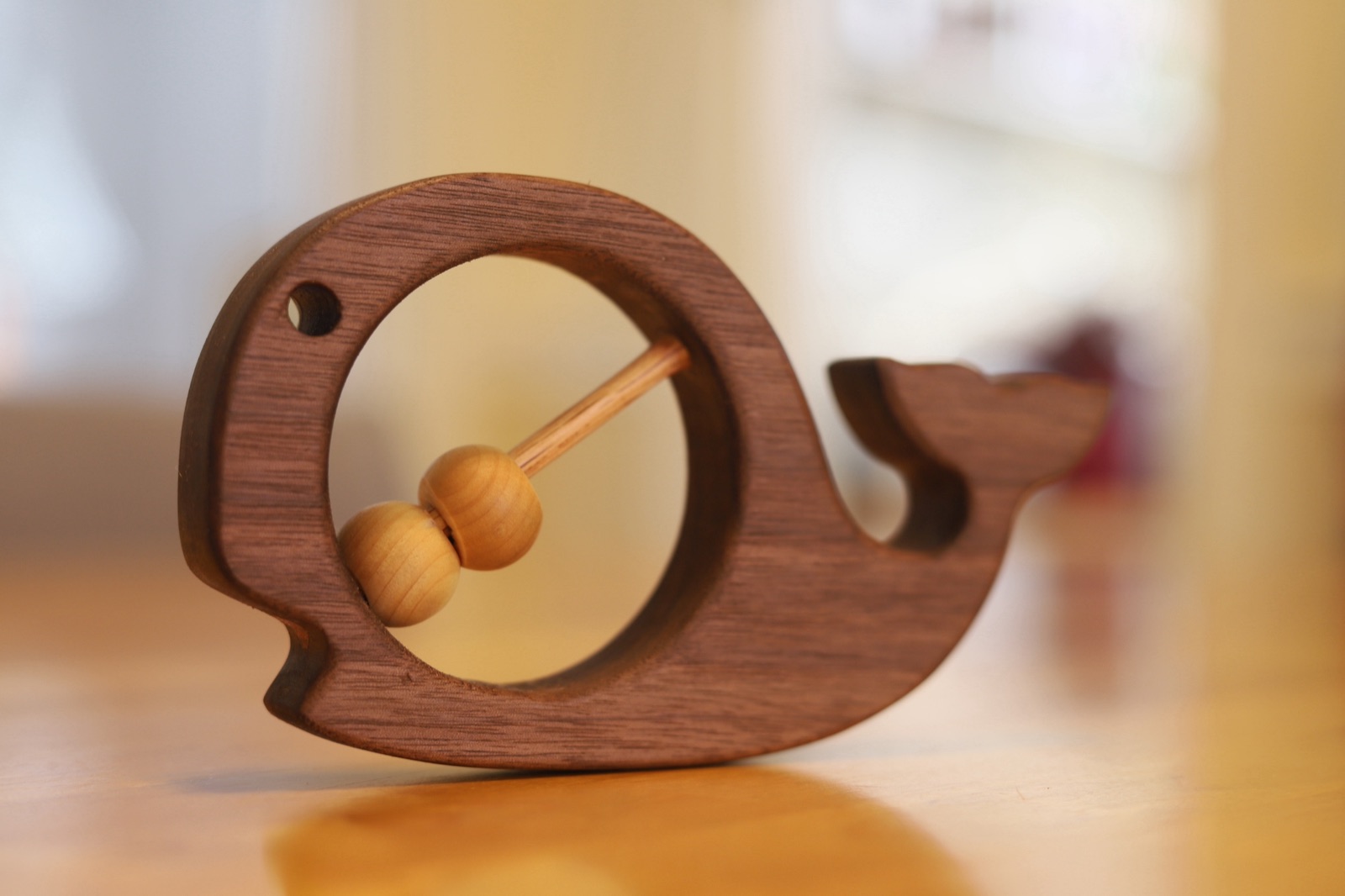 Handmade walnut whale rattle with wooden beads